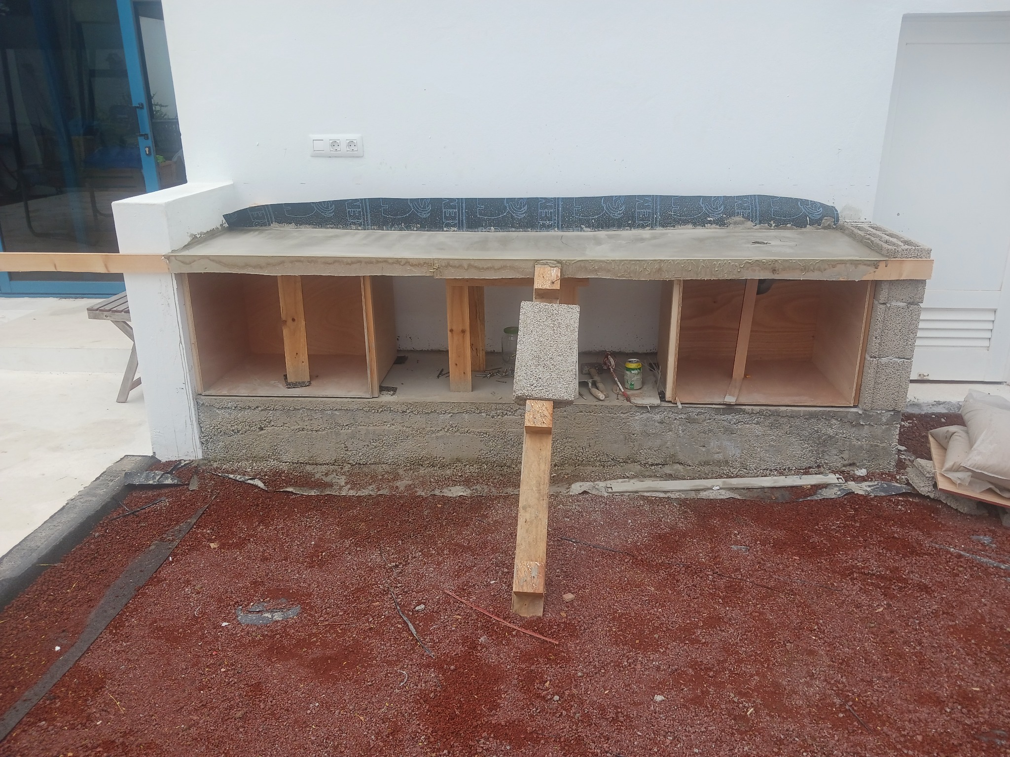 Outdoor kitchen under construction in Playa Blanca, with masonry base and concrete worktop