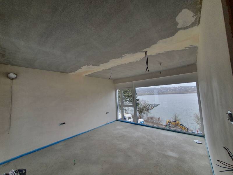 Living room in Germany before flooring and paintwork, with the floor and walls being prepared